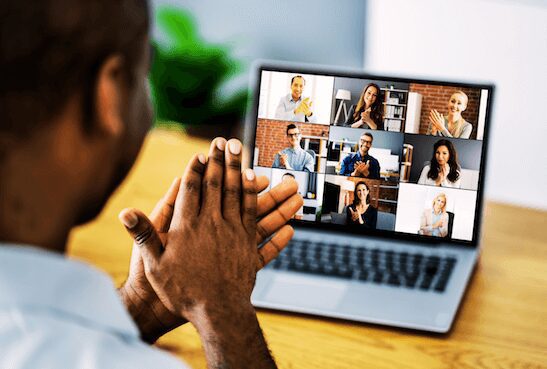 Man clapping during video call, indicating remote work collaboration, leadership trust and support.